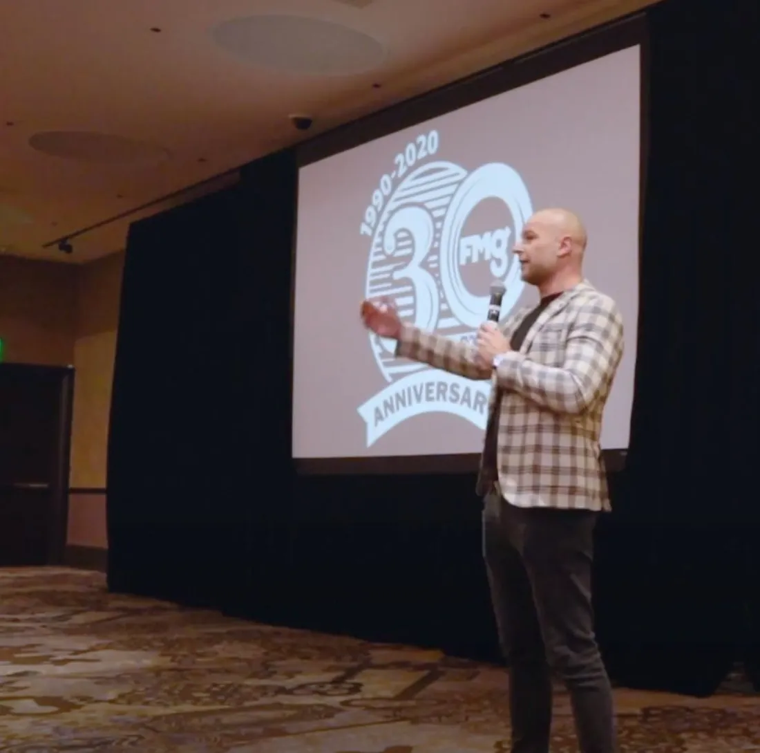 Gary Garth on stage, speaking to a conference room