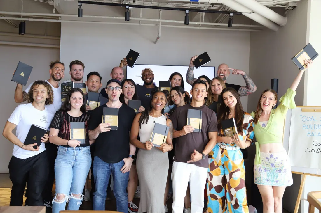 The elev8 team holding up copies of the planner