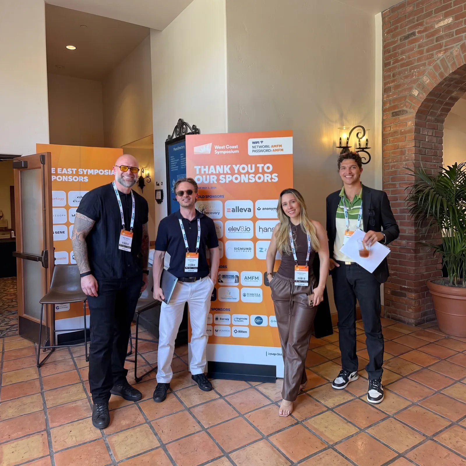 Gary Garth and the elev8 team at the West Coast Symposium, in front of the Thank You to Our Sponsors board